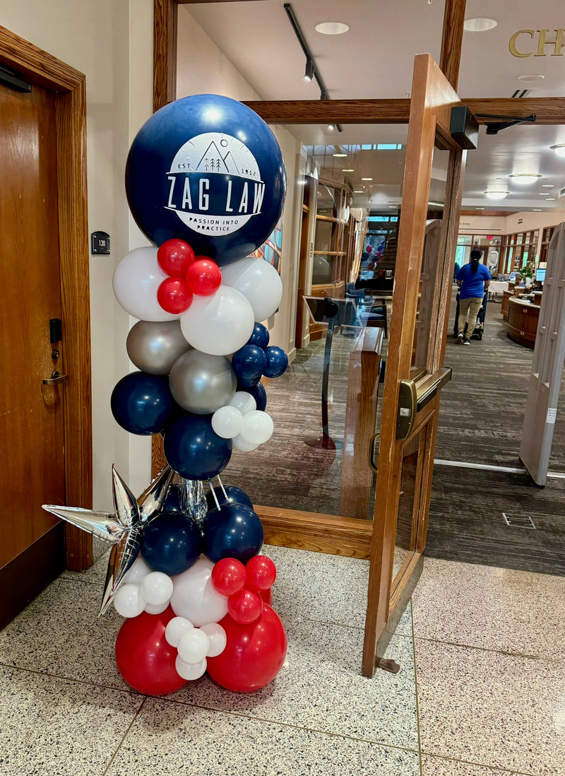 Navy red and silver party pole with a Zag Law logo balloon