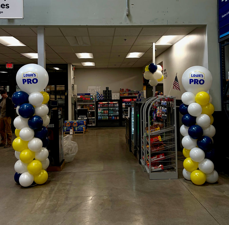 Yellow white and navy balloon columns at a Lowe's store entrance