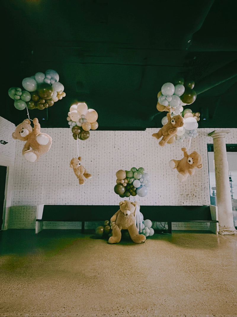 Teddy bear baby shower with floating bears and sage balloon clusters