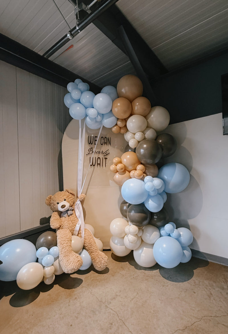 We Can Bearly Wait baby shower backdrop with blue and tan garland
