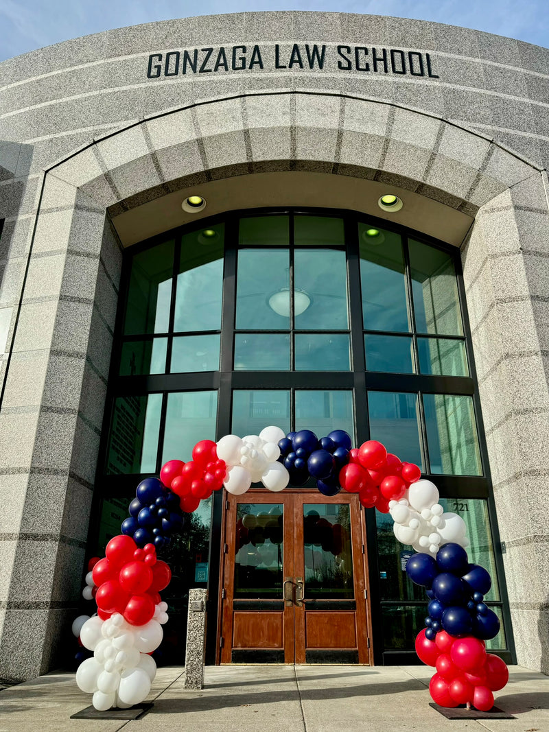 Red navy and white balloon arch at the Gonzaga Law School doors
