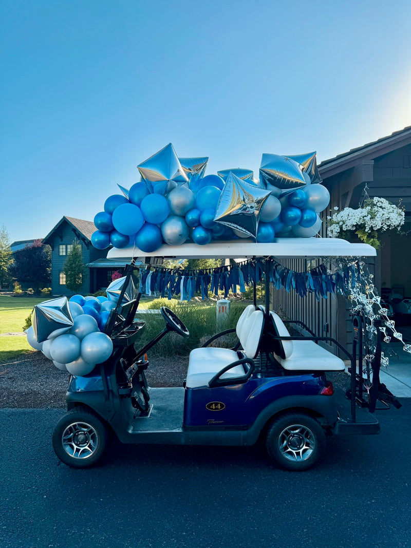 Golf cart decorated with blue and silver balloons and gift bows
