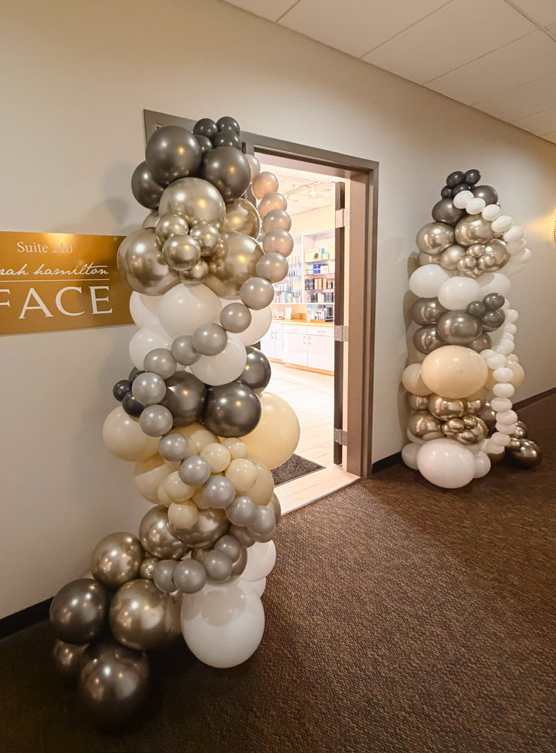 Chrome and cream free standing garlands framing an office doorway