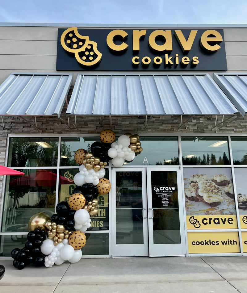 Black and gold balloon garland on the Crave Cookies storefront