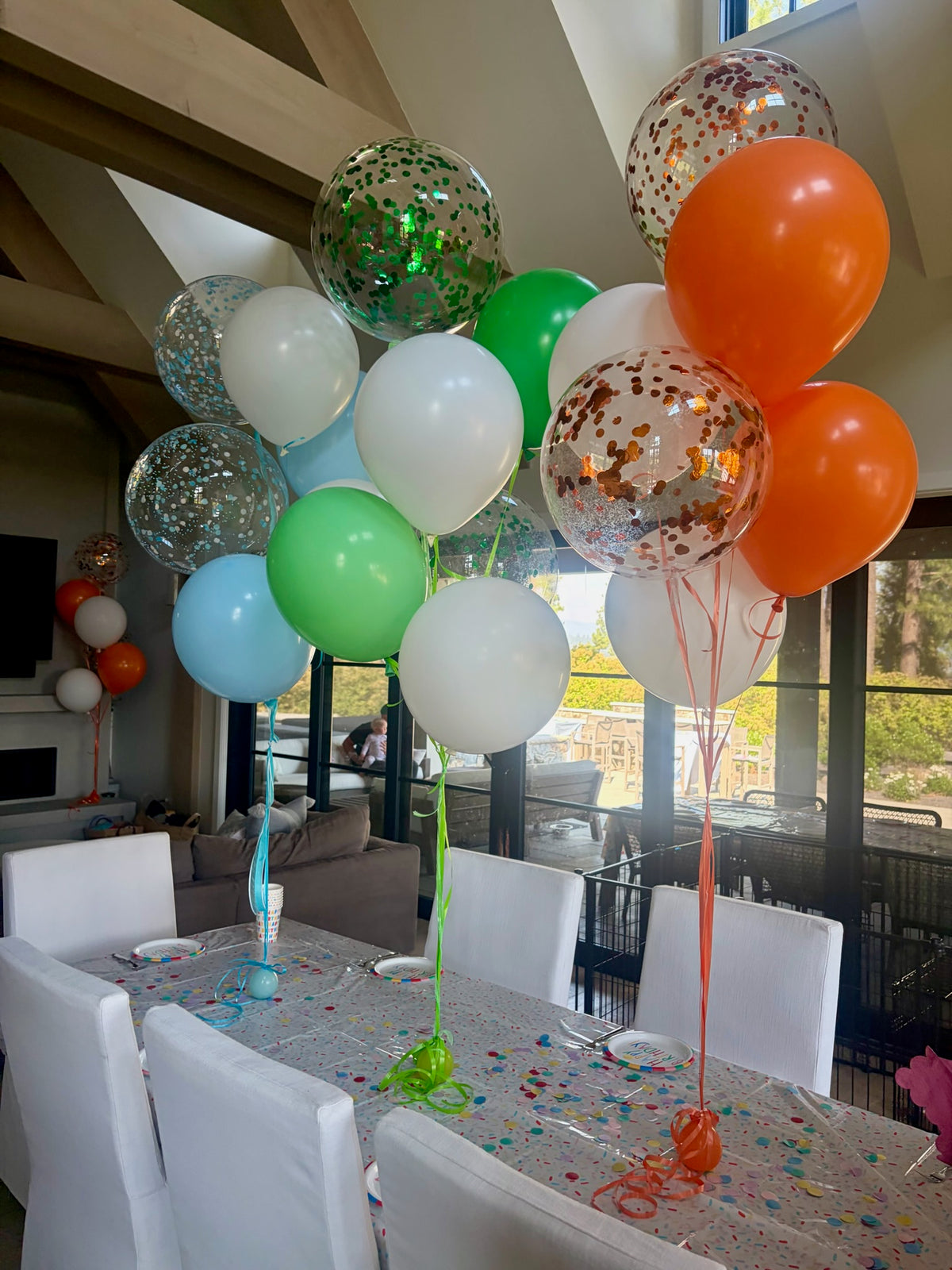 Colorful helium balloon bouquets on a table