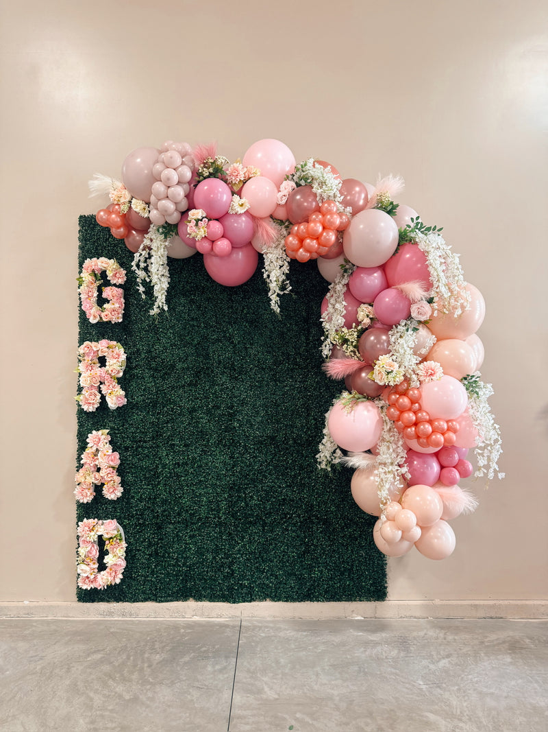 GRAD greenery wall with blush balloon garland and florals