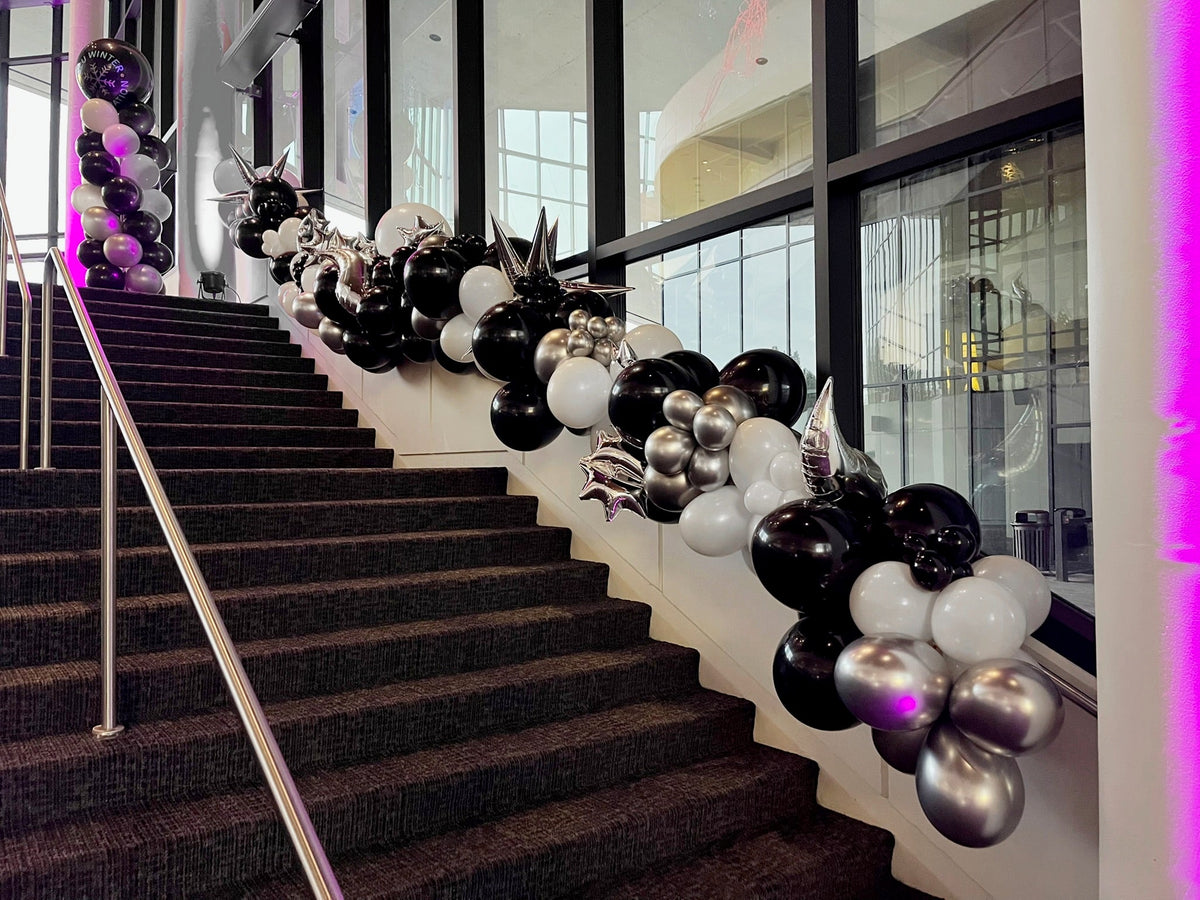Black and chrome balloon installation down a grand staircase at a Spokane venue