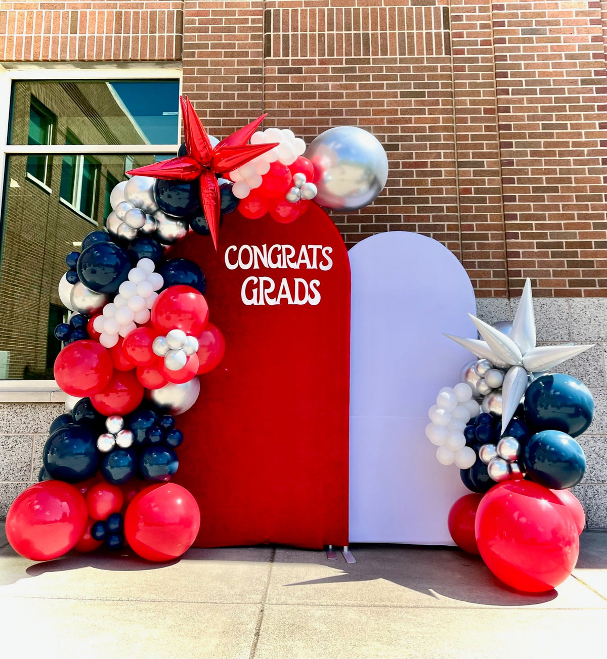 Graduation balloon backdrop arch in red, white and navy by Air with a Flair