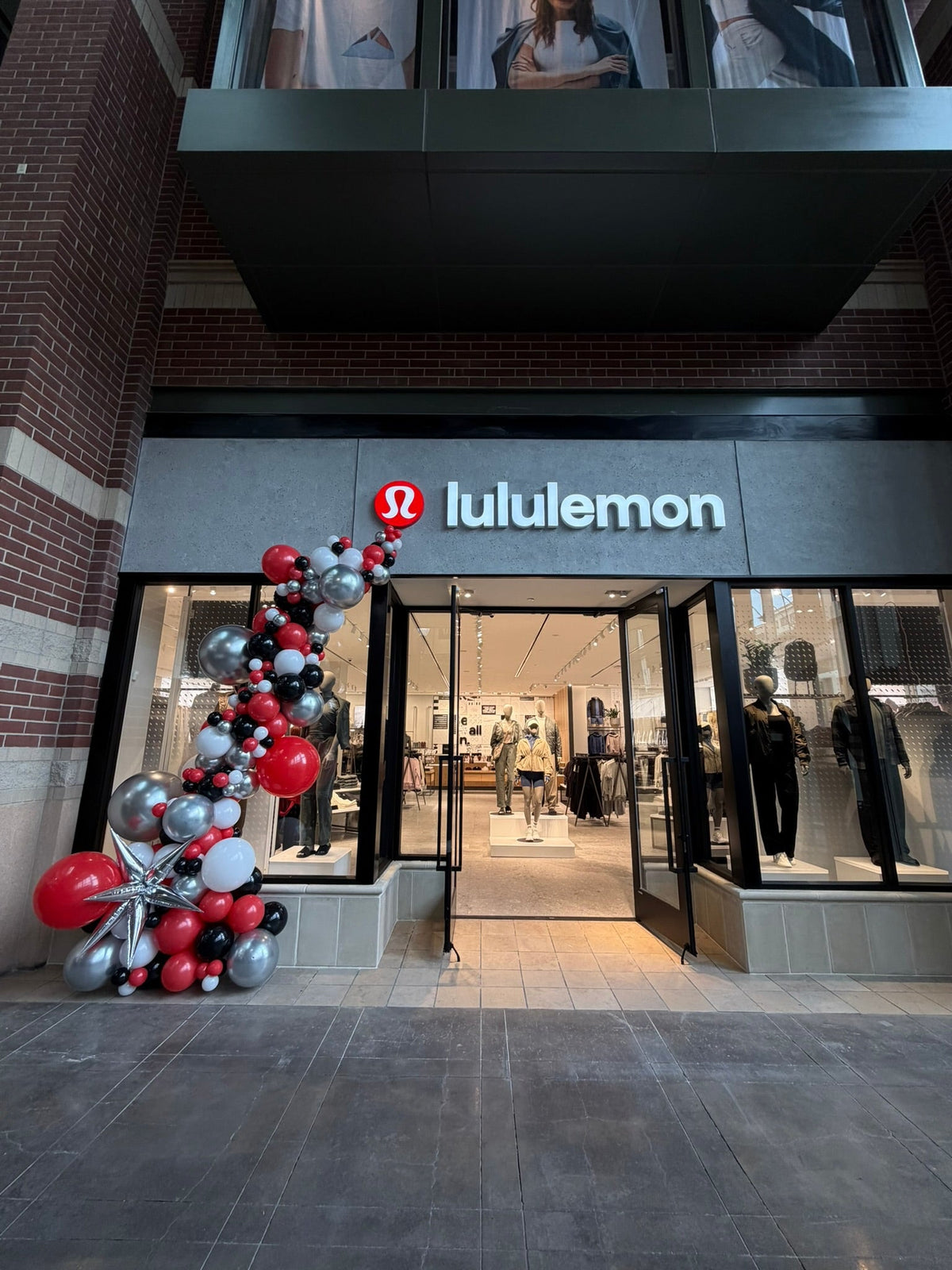 Balloon columns framing a Lululemon store entrance by Air with a Flair