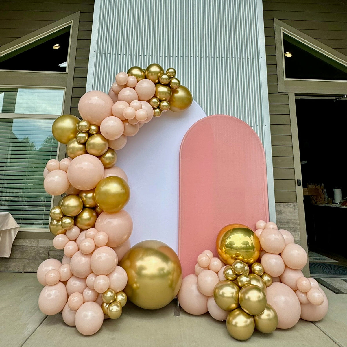 Blush, cream and gold organic balloon arch with backdrop panels by Air with a Flair